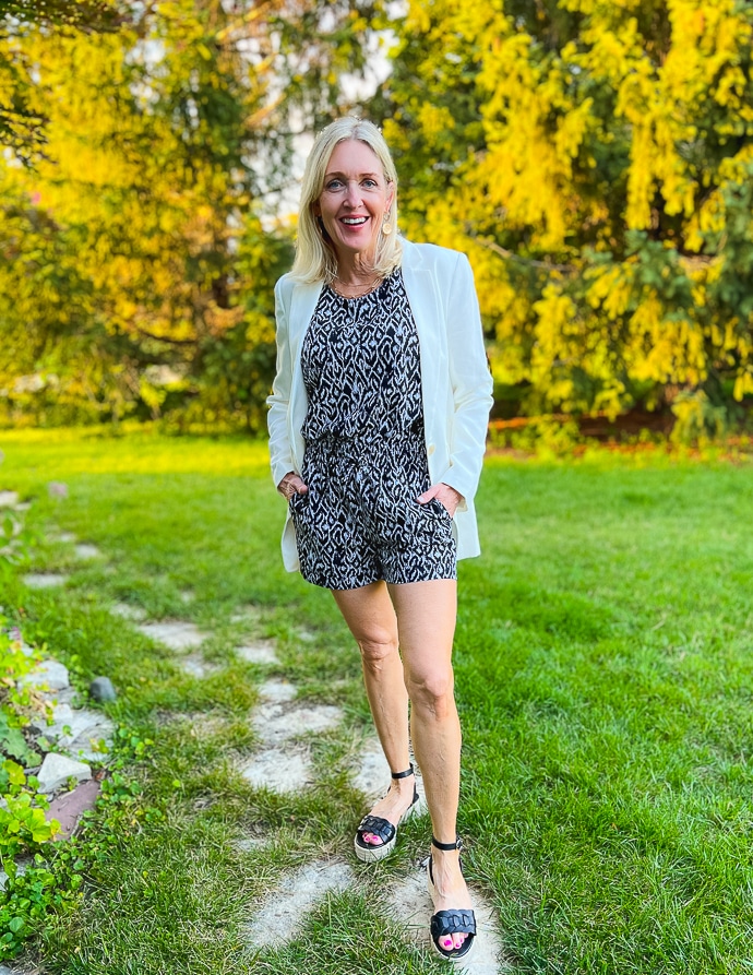 woman wearing a white blazer and black and white romper